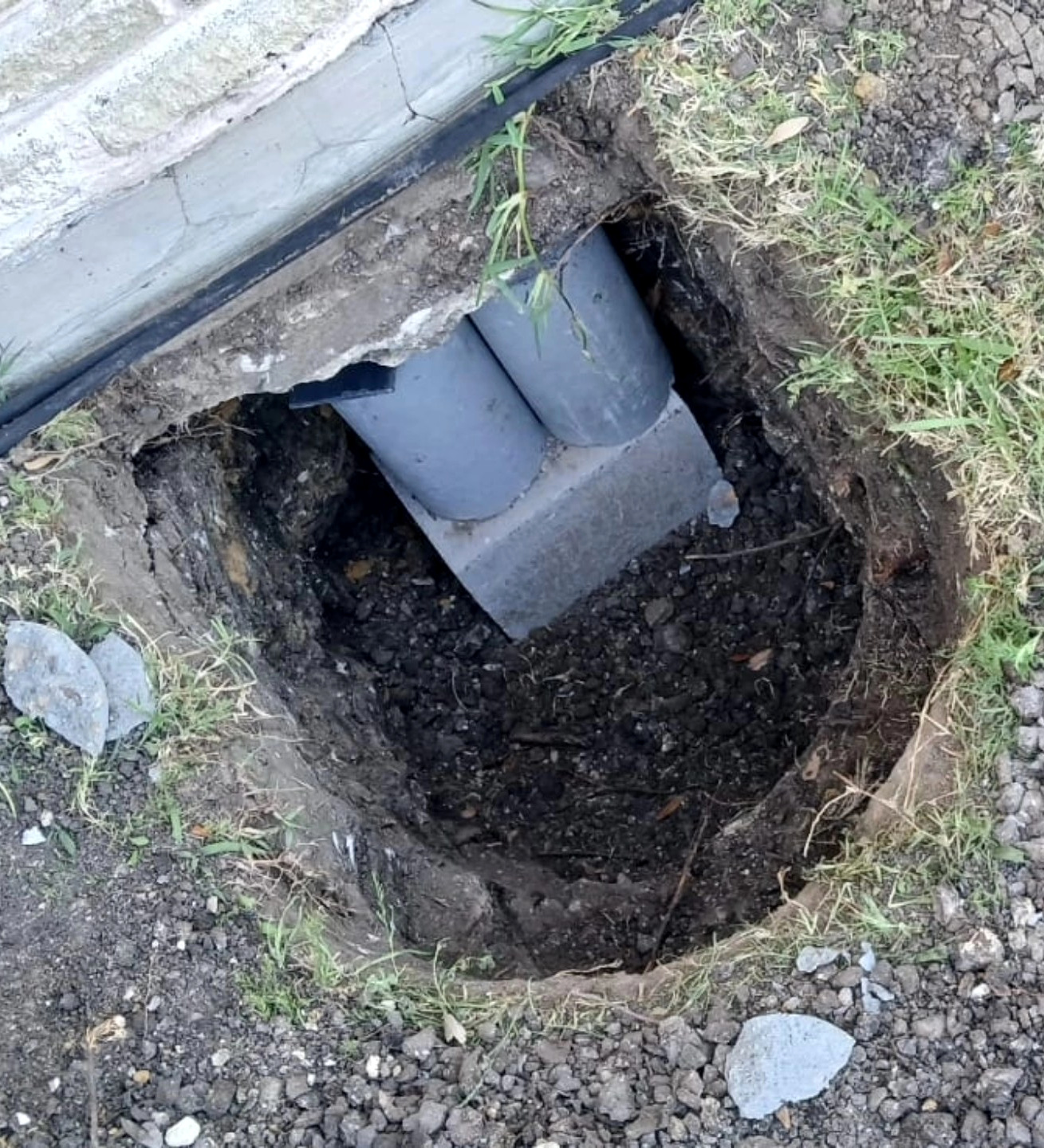 An excavation opened beside a house foundation