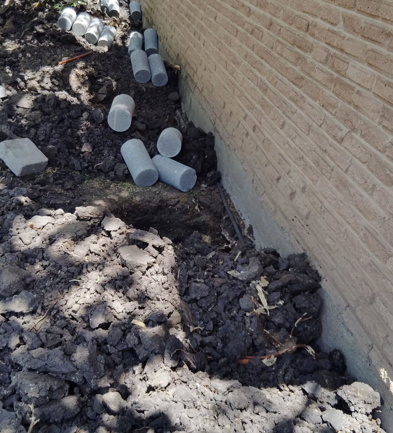 Elevation readings being taken beside a brick wall
